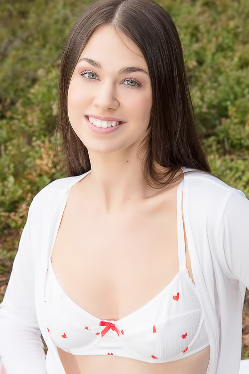Stella Bloom teases on blanket in sheer red hearts lingerie outdoors